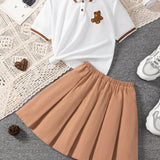 Conjunto de camiseta de manga corta con cuello polo y parche de oso y falda plisada en estilo de verano universitario para nina preadolescente