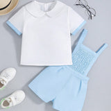 Conjunto de verano para bebe nino: camiseta de manga corta con cuello muneca y detalle de ribete contrastante y pantalones cortos con tirantes y detalles de cinta